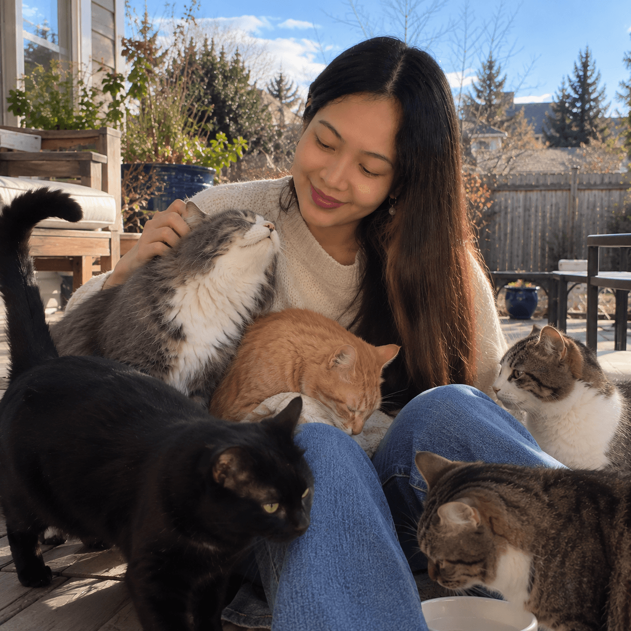 Marne spending time with her cats outdoors