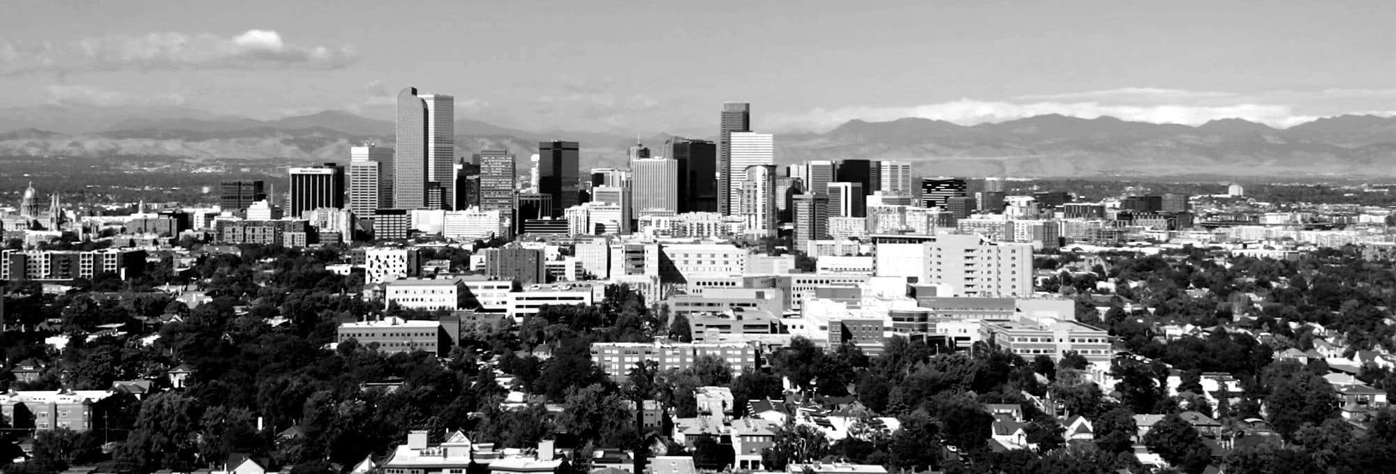 Downtown Denver skyline in front of the Rocky Mountains