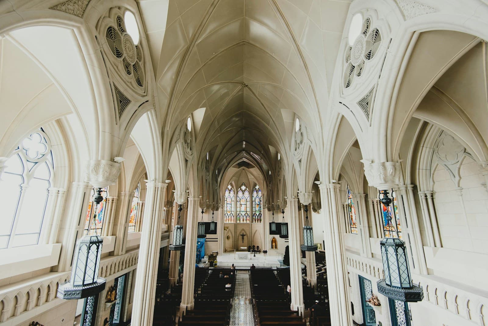 Arched church interior with rows of pews