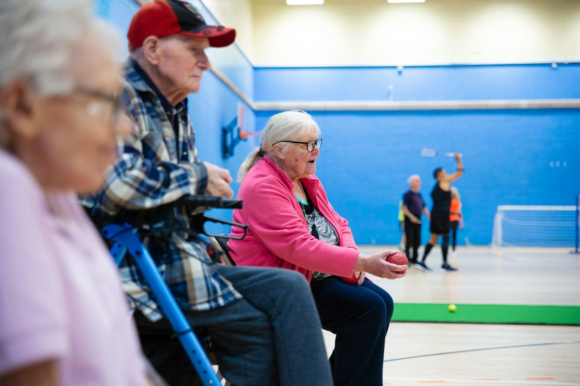 Older adults playing a game together in a community gymnasium